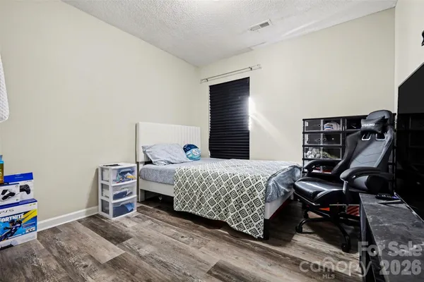 a bedroom with a bed and a desk