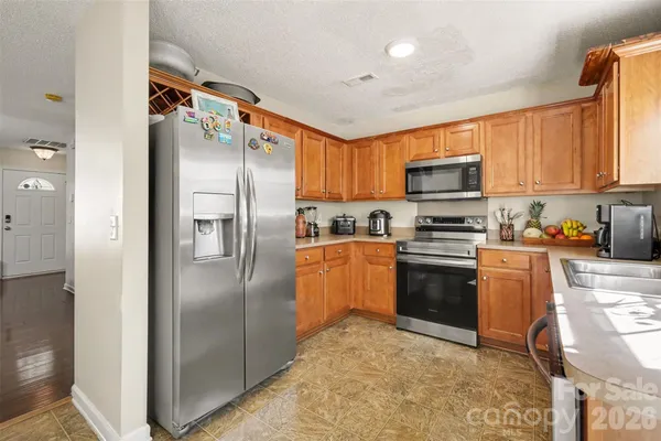 a kitchen with granite countertop a refrigerator and a sink
