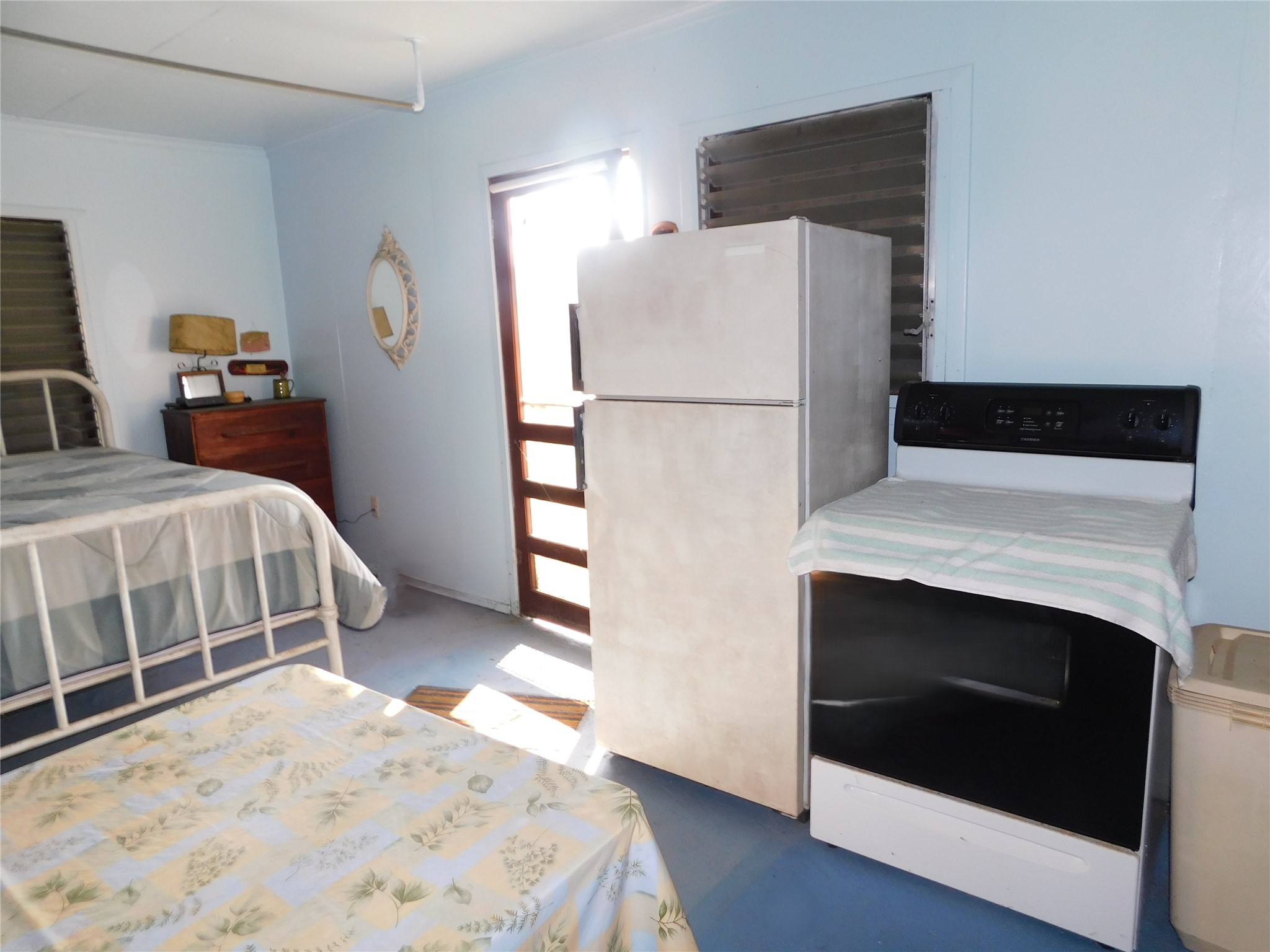 266 First Street Port Lavaca, TX 77979 - Photo 5 of 18 a bedroom with a bed and a refrigerator