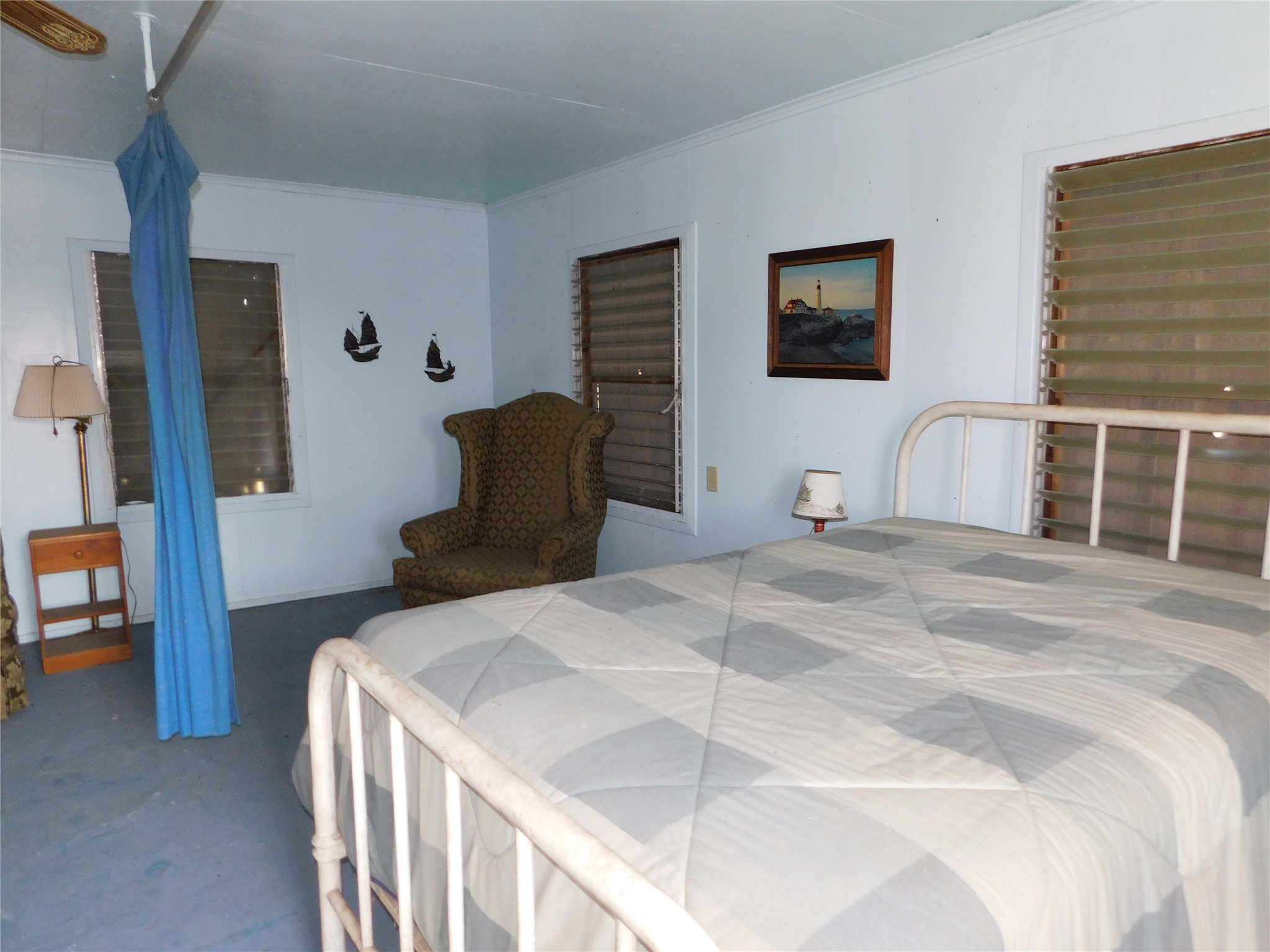 266 First Street Port Lavaca, TX 77979 - Photo 6 of 18 a bedroom with a bed and chair with mirror