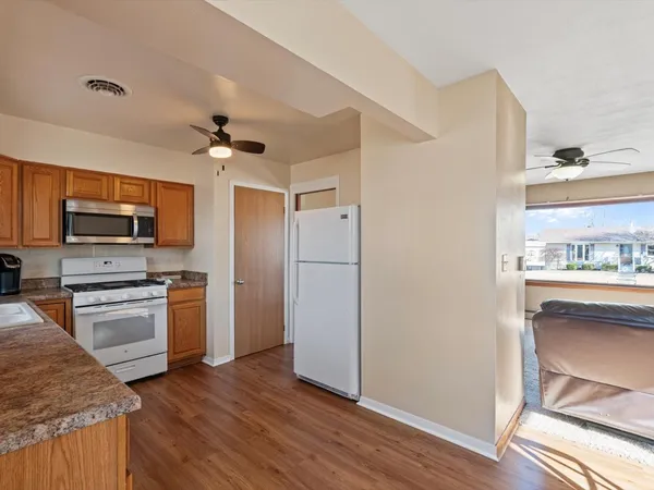 a kitchen with stainless steel appliances a stove a refrigerator and a sink