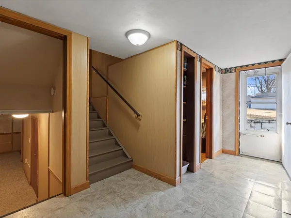 a view of hallway with stairs and furniture