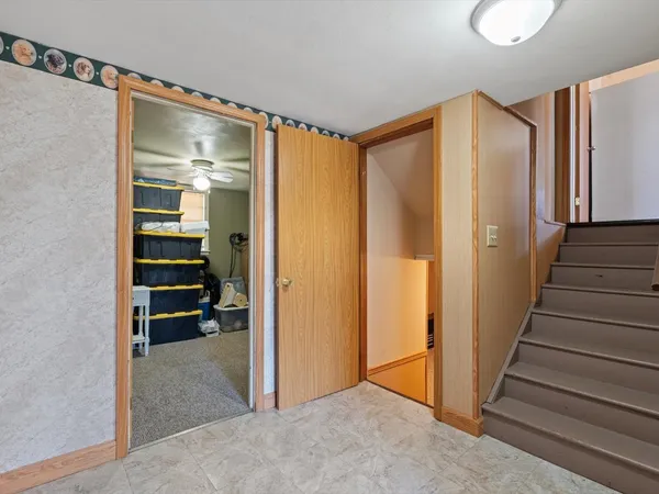 a view of a hallway with wooden walls and entryway