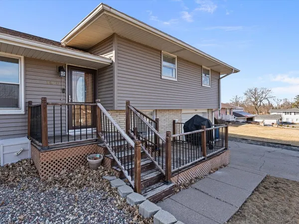a view of a house with wooden deck