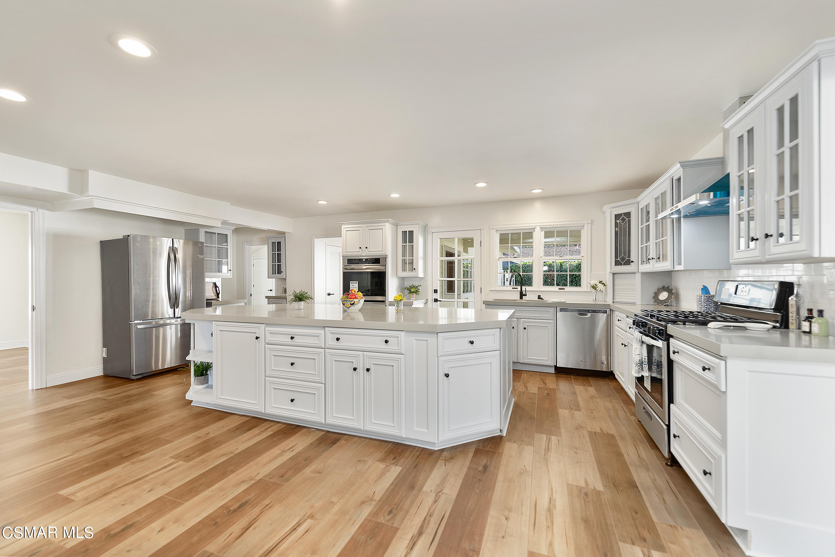 2959 Happy Lane Simi Valley, CA 93065 - Photo 20 of 92 a large kitchen with stainless steel appliances granite countertop a lot of counter space and wooden floors
