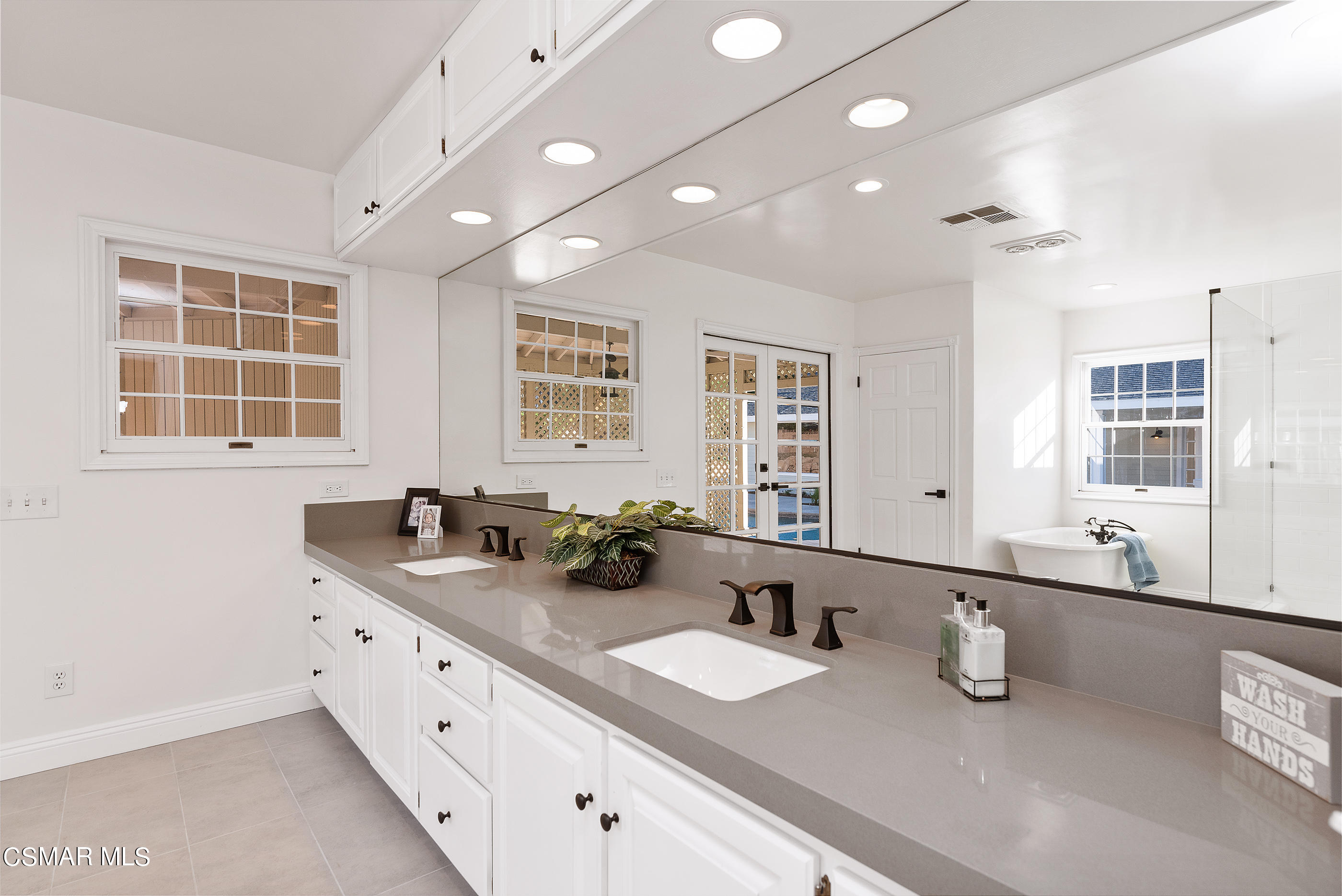2959 Happy Lane Simi Valley, CA 93065 - Photo 54 of 92 a bathroom with double vanity sinks and a mirror