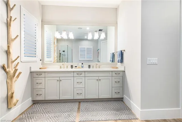 a spacious bathroom with a double vanity sink mirror and