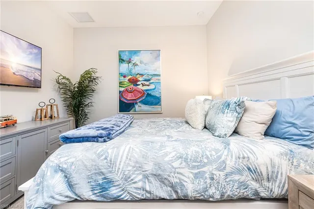 a bed sitting in a bedroom with furniture