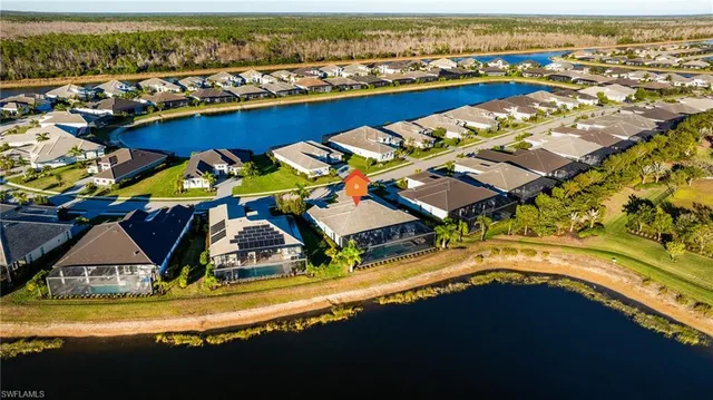 an aerial view of a house with swimming pool and ocean view