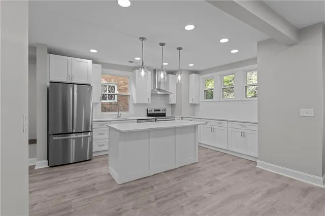 a kitchen with a refrigerator and a sink