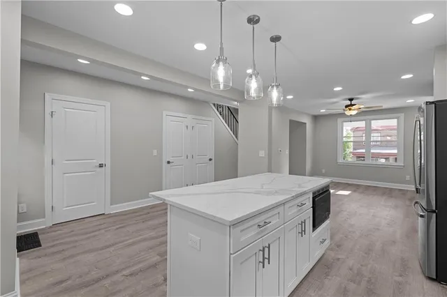 a kitchen with a refrigerator and a sink