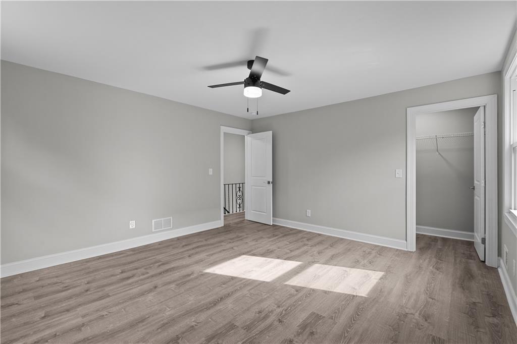 748 Anaheim Street Pittsburgh, PA 15219 - Photo 21 of 29 an empty room with wooden floor chandelier fan and windows