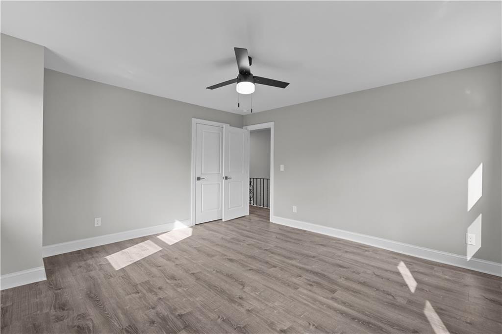 748 Anaheim Street Pittsburgh, PA 15219 - Photo 23 of 29 a view of an empty room and window a ceiling fan and wooden floor