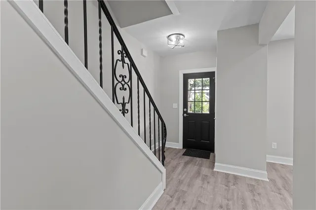a view of an entryway with wooden floor