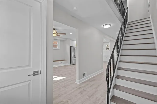 a view of an entryway with wooden floor