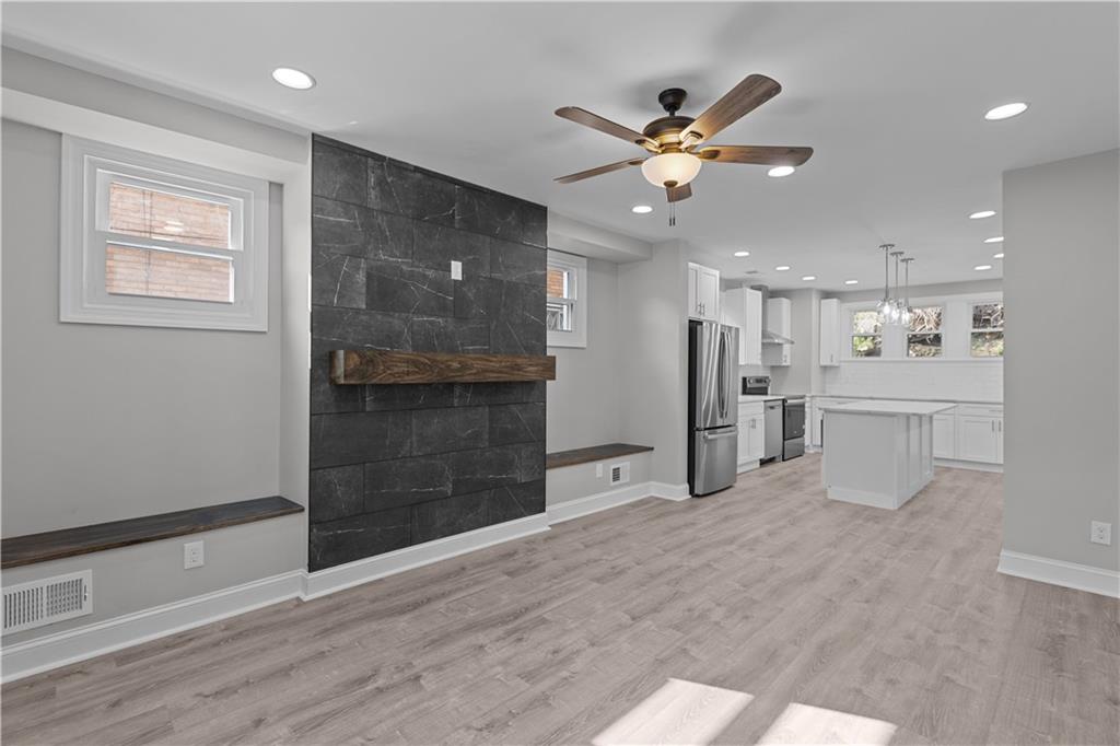 748 Anaheim Street Pittsburgh, PA 15219 - Photo 7 of 29 a view of a livingroom with a ceiling fan and wooden floor