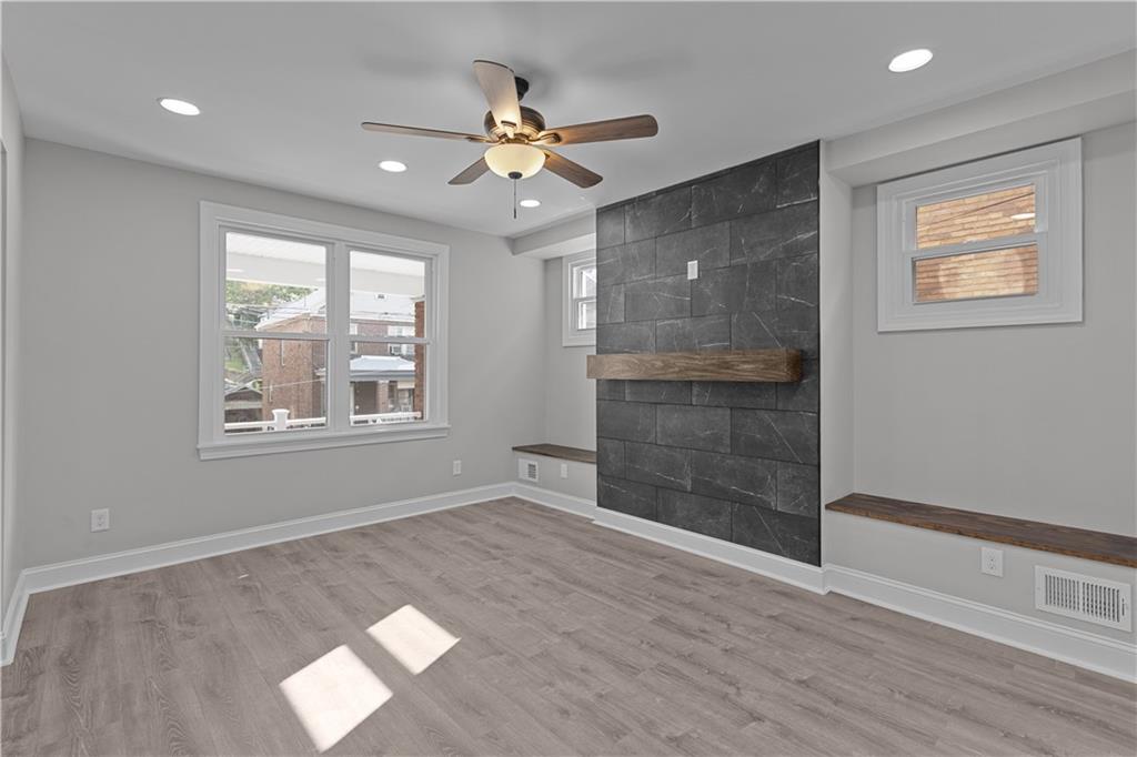 748 Anaheim Street Pittsburgh, PA 15219 - Photo 9 of 29 a view of an empty room with a window and wooden floor