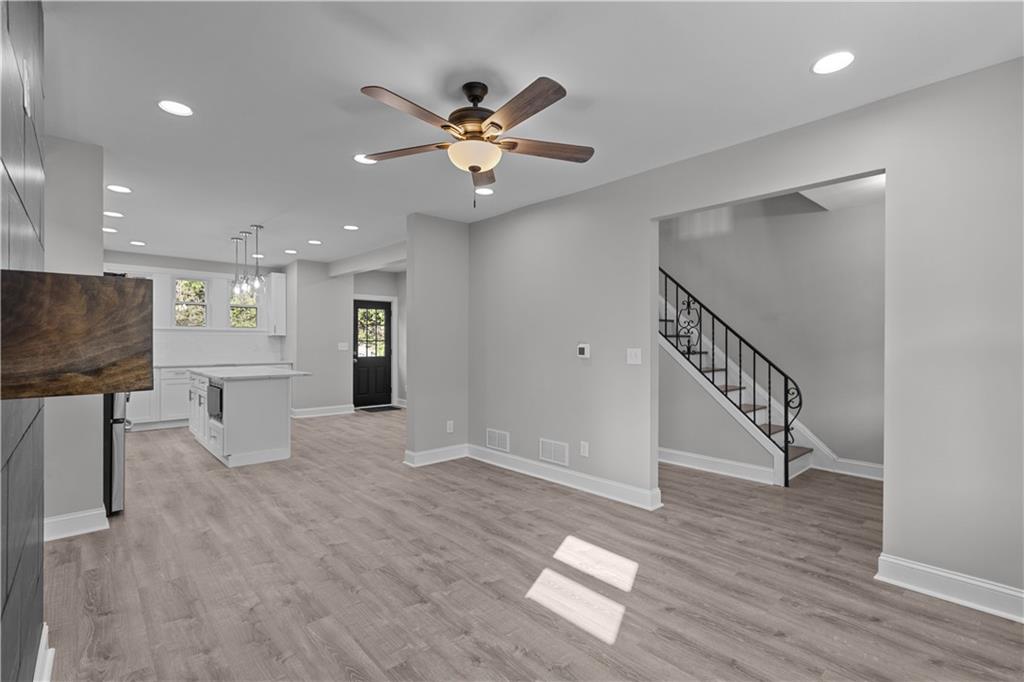 748 Anaheim Street Pittsburgh, PA 15219 - Photo 10 of 29 a view of an empty room with wooden floor and a ceiling fan