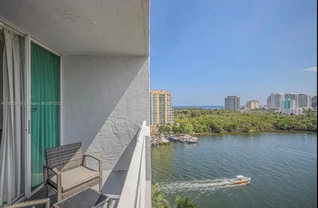 a view of a lake with chairs