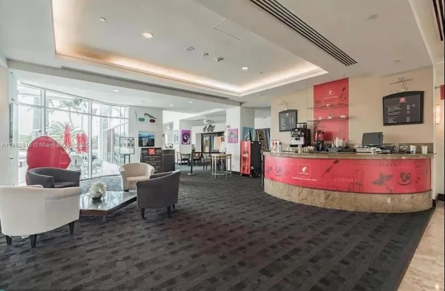 a view of a patio with chairs and a table under an umbrella