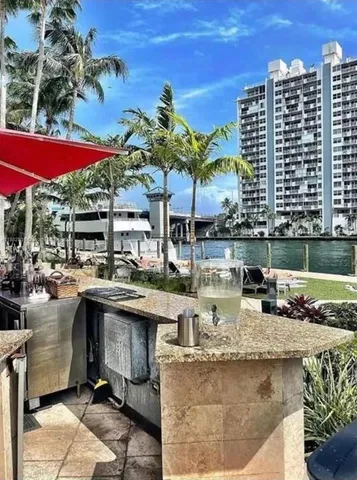 a view of a swimming pool with a patio and fire pit