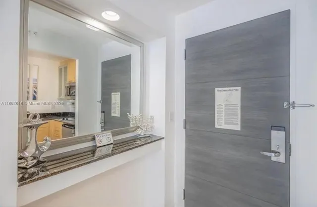 a view of a bathroom with sink and mirror