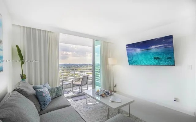 a living room with furniture and a flat screen tv