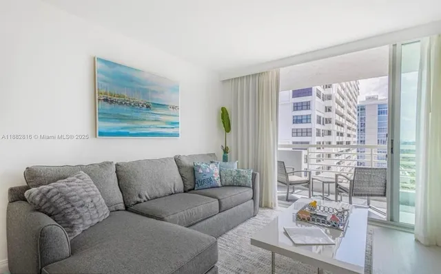 a living room with furniture and a large window