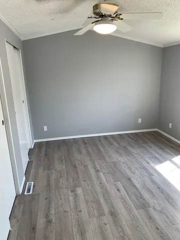 a view of a room with wooden floor