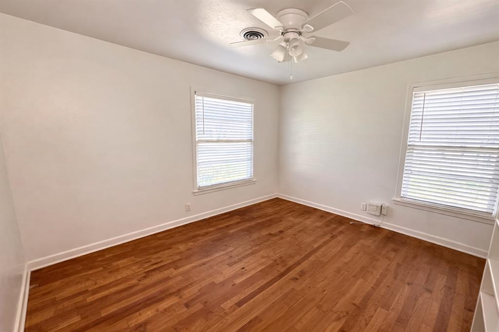 809 Crescent Street Denton, TX 76201 - Photo 12 of 24 wooden floor in an empty room with a window