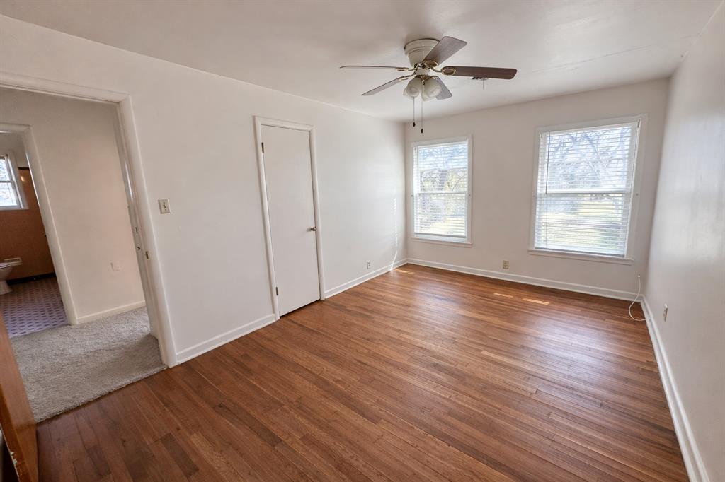 809 Crescent Street Denton, TX 76201 - Photo 15 of 24 a view of an empty room with wooden floor and a window