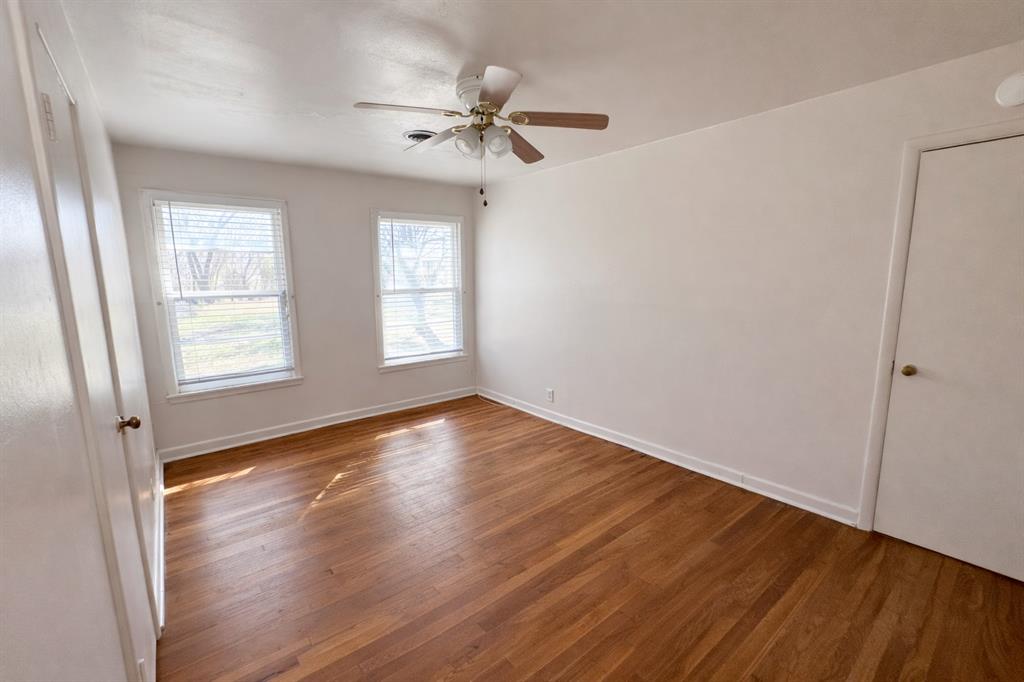 809 Crescent Street Denton, TX 76201 - Photo 16 of 24 an empty room with wooden floor fan and windows