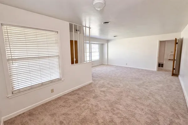 a view of an empty room with a window