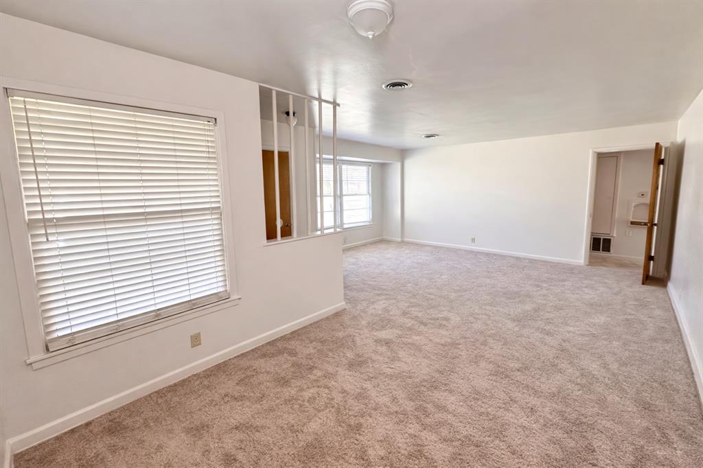 809 Crescent Street Denton, TX 76201 - Photo 4 of 24 a view of an empty room with a window