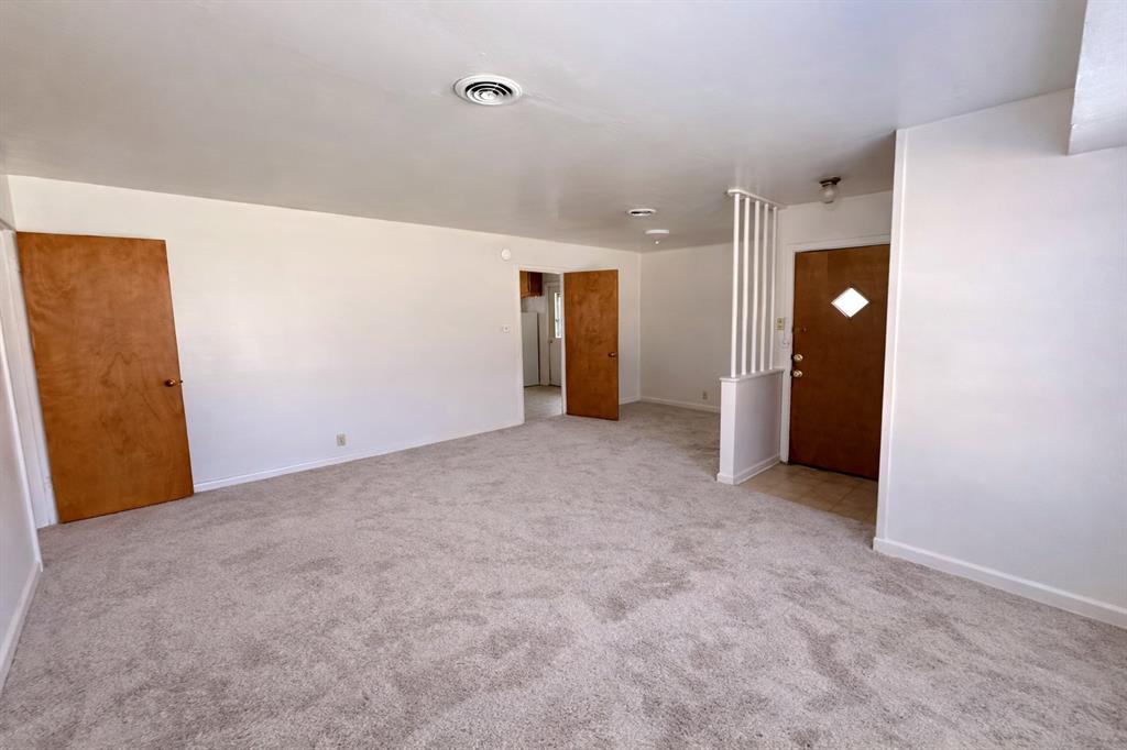 809 Crescent Street Denton, TX 76201 - Photo 5 of 24 an empty room with closet and mirror