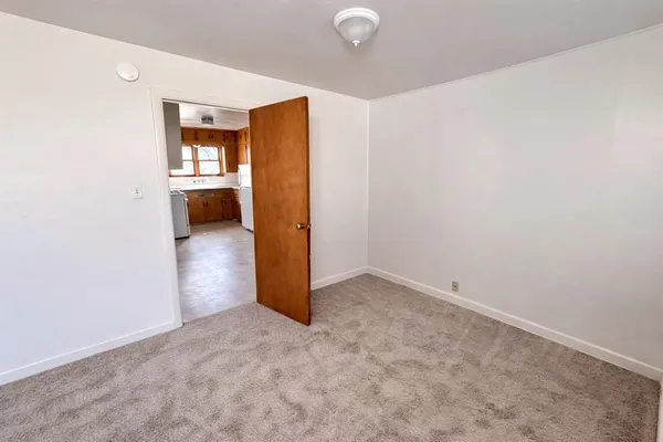 a kitchen with a refrigerator a stove top oven