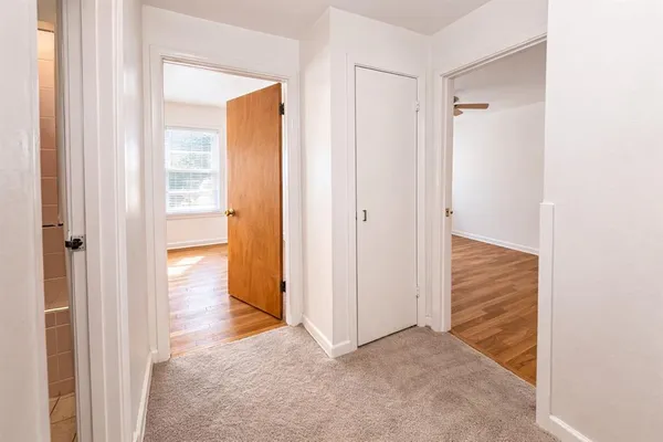 a view of empty room with wooden floor