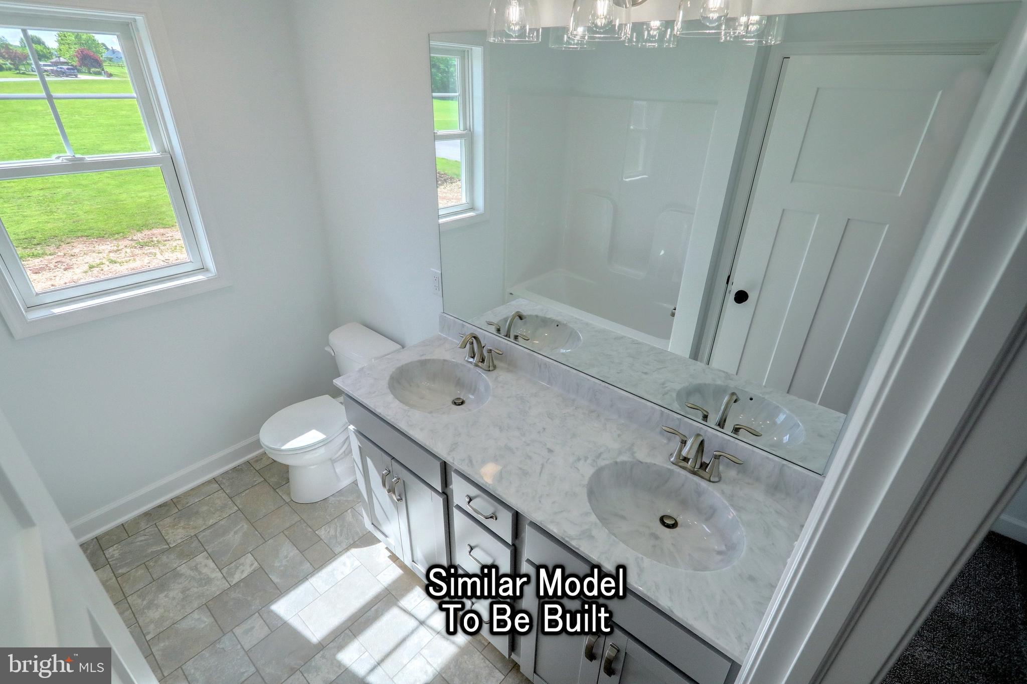 3227 Oxford Road New Oxford, PA 17350 - Photo 29 of 66 a bathroom with a sink a toilet and shower