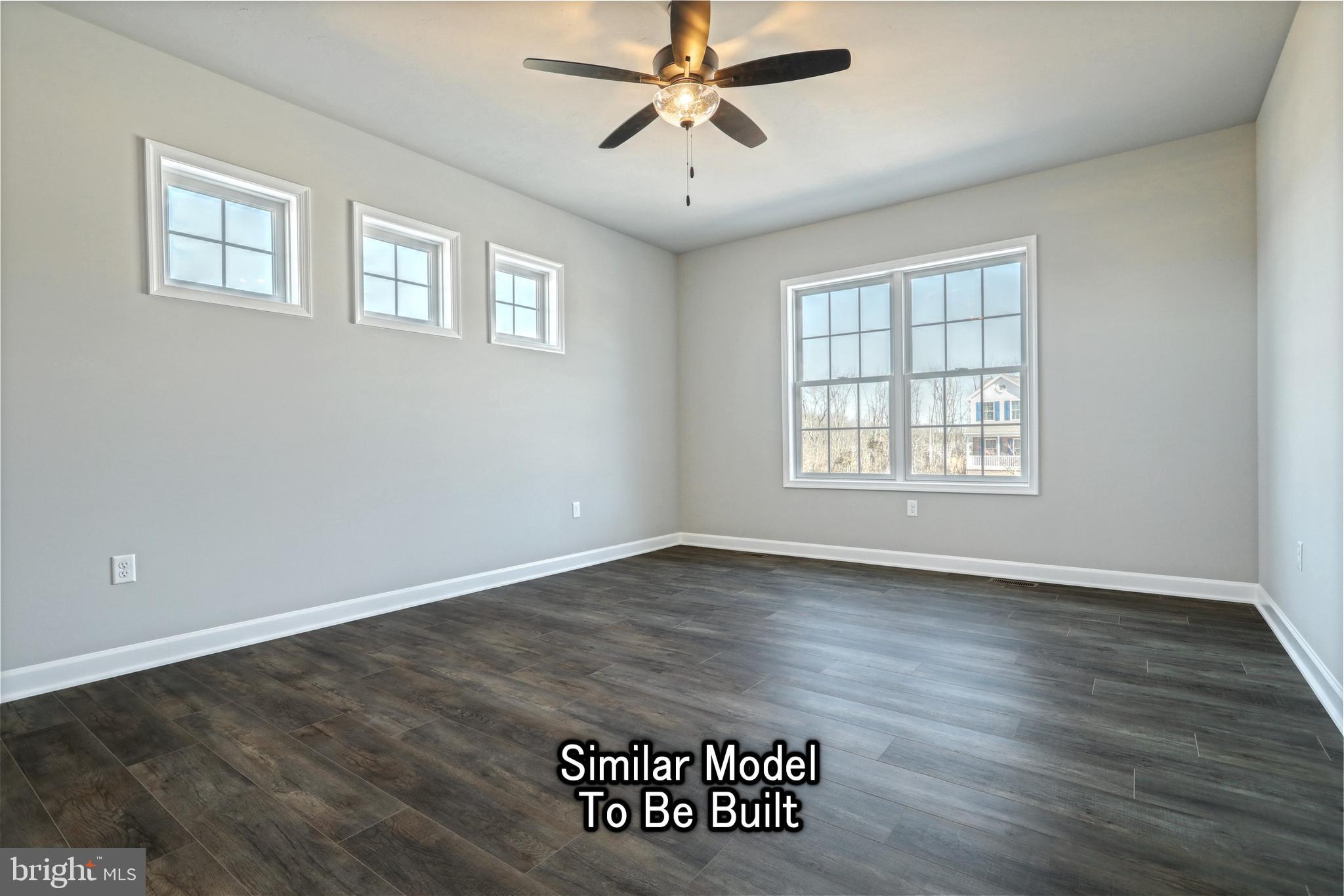 3227 Oxford Road New Oxford, PA 17350 - Photo 64 of 66 an empty room with wooden floor ceiling fan and windows