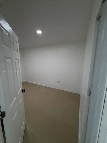 a view of an empty room and a window