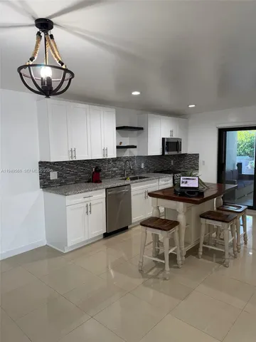 a kitchen with cabinets a sink and appliances
