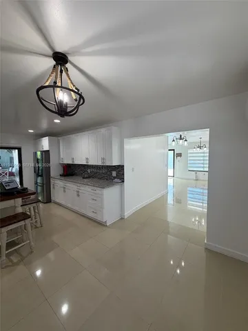 a view of a kitchen with a sink and dishwasher cabinets