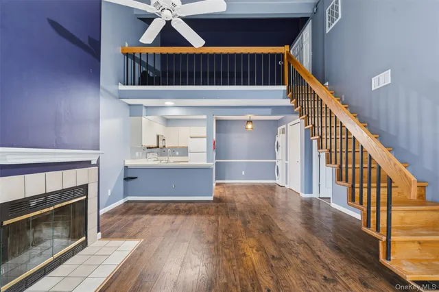 a view of staircase and kitchen with wooden floor