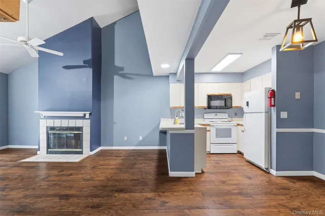a view of kitchen with sink and wooden floor