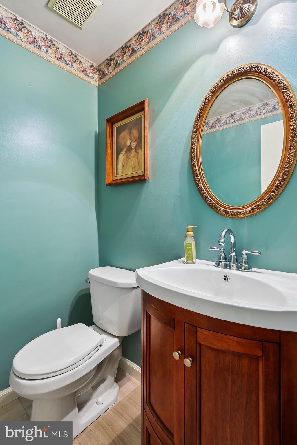14822 Rose Trellis Place Silver Spring, MD 20906 - Photo 43 of 65 a bathroom with a toilet a sink and mirror
