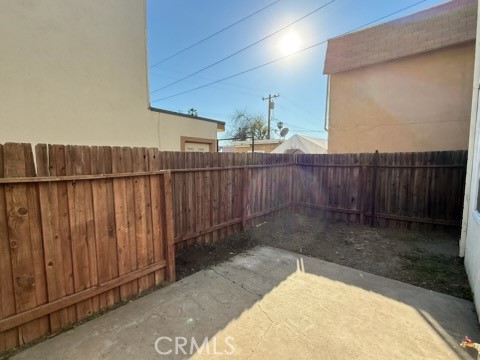 249 East Jackson Street, Unit C Rialto, CA 92376 - Photo 12 of 12 a view of a backyard with wooden fence