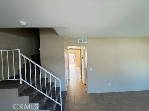 a view of a hallway with wooden floor and entryway