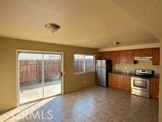 249 East Jackson Street, Unit C Rialto, CA 92376 - Photo 5 of 12 a kitchen with a stove a fridge and a sink
