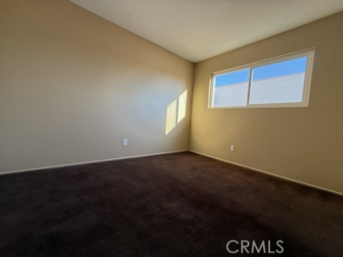 249 East Jackson Street, Unit C Rialto, CA 92376 - Photo 7 of 12 a view of an empty room with wooden floor and a window