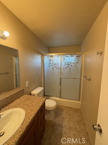 249 East Jackson Street, Unit C Rialto, CA 92376 - Photo 9 of 12 a bathroom with a granite countertop sink toilet and shower